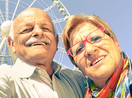 smiling retired couple after restorative dental treatment