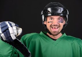 man in need of tooth replacement after hockey injury